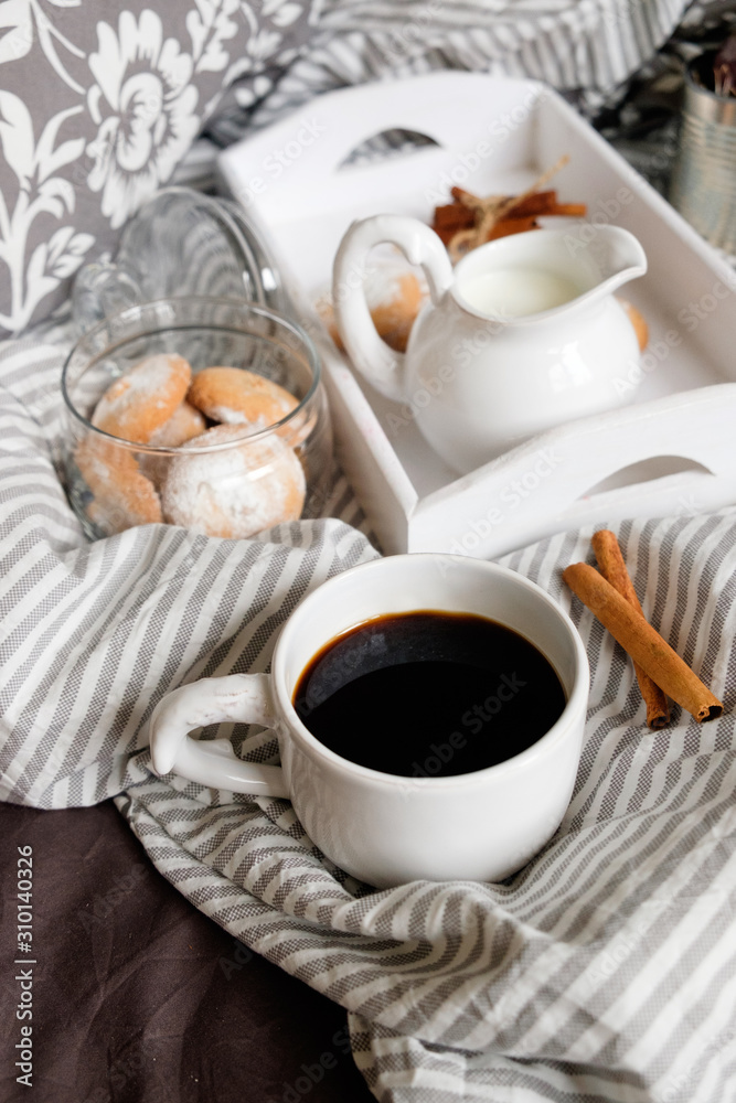 cozy flat ley in scandinavian style. Coffee with cookies in bed. 