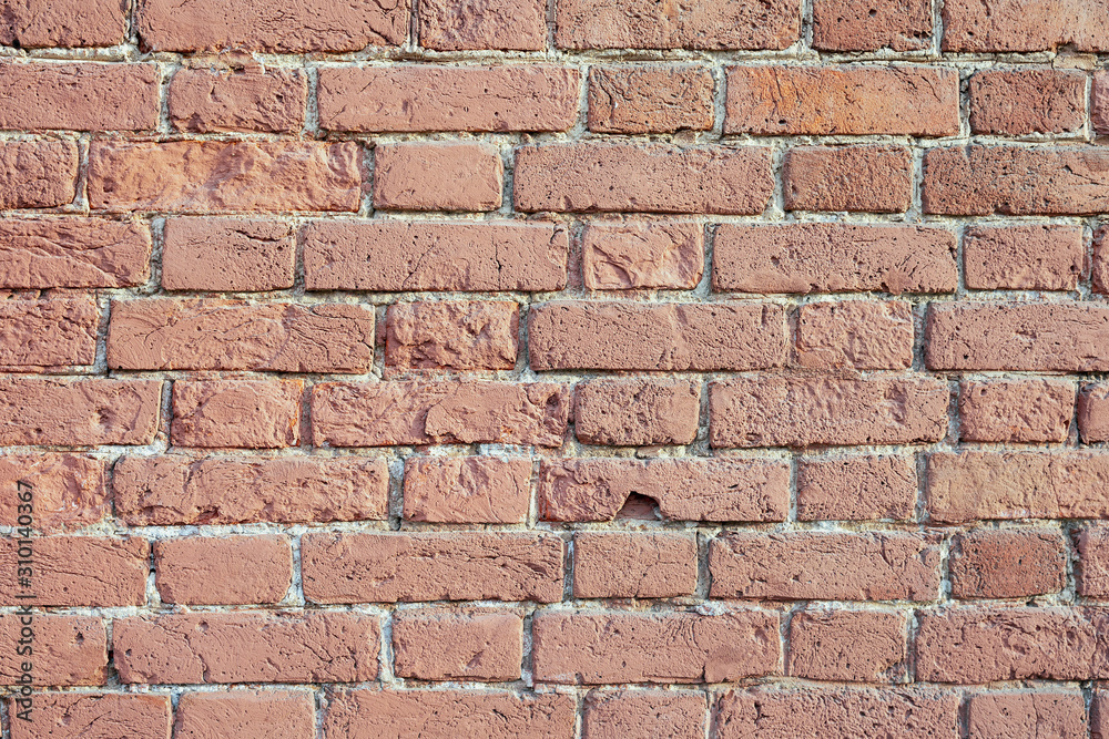 Old brick wall of bricks of different sizes as a background Old brick wall of bricks of different sizes as a background