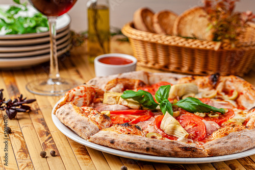 Italian food concept. Thin pizza with thick sides on a white plate. background image. copy space