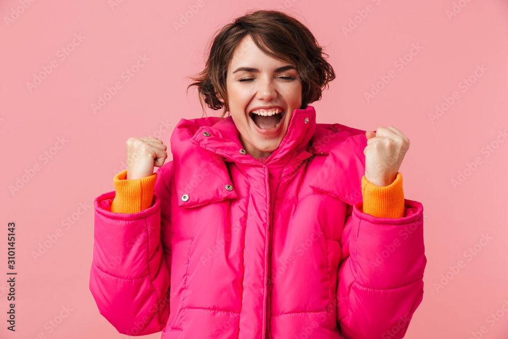 Portrait of excited woman making winner gesture and screaming Portrait of excited woman making winner gesture and screaming