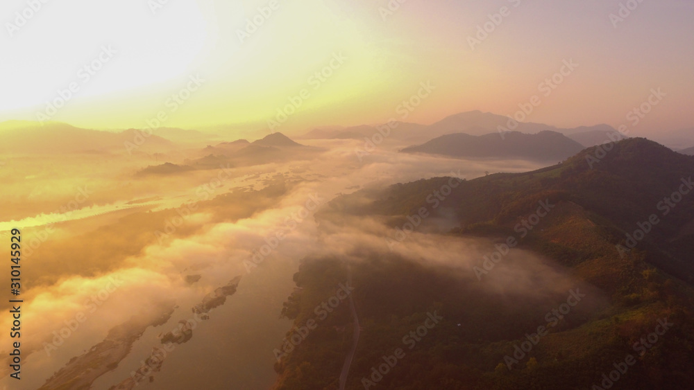 Autumn landscape high angle aerial drone shot. Above Fog or mist over beautiful colorful woods landscape.