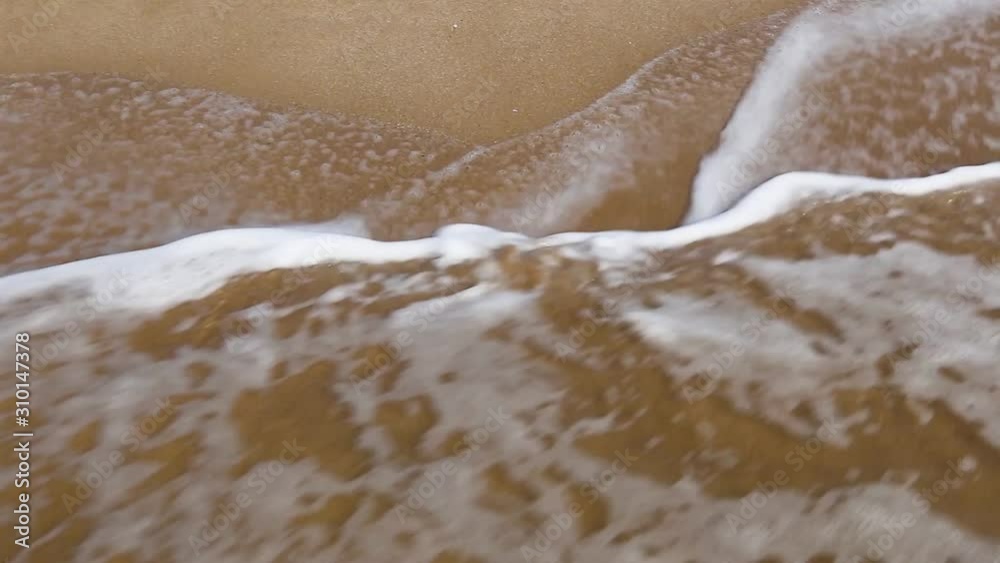 Handwritten inscription 30% on a sandy sea beach is washed by the sea wave with foam on a summer sunny day. Disappearing statistics and percent writing Handwritten inscription 30% on a sandy sea beach is washed by the sea wave with foam on a summer sunny day. Disappearing statistics and percent writing