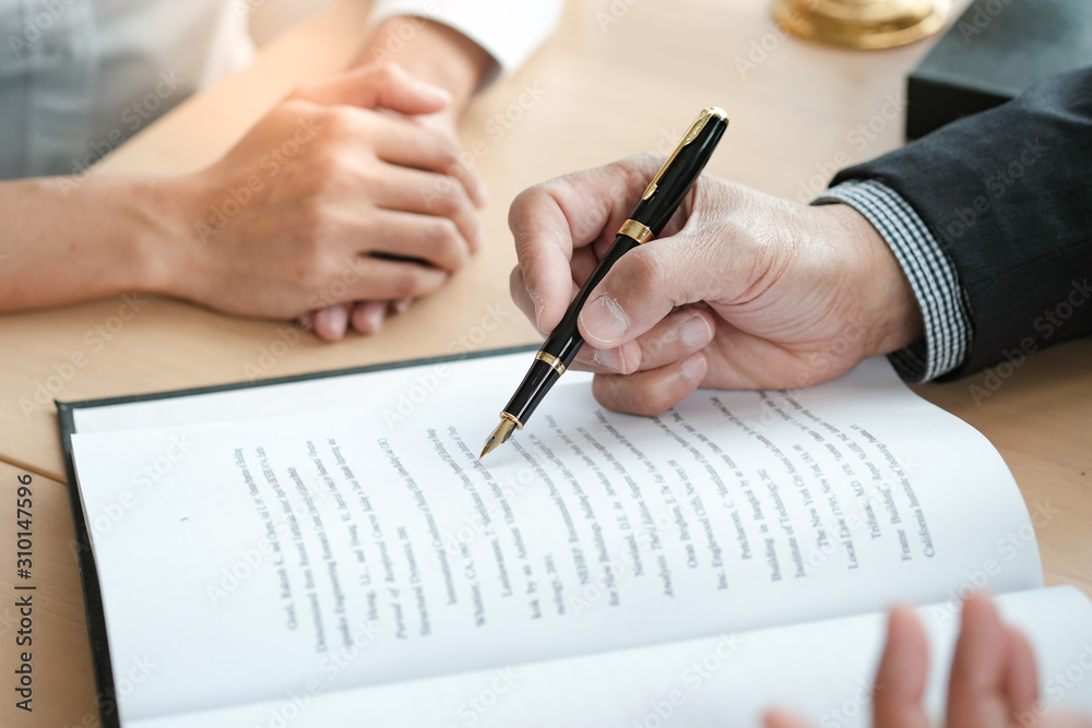 Legal counsel presents to the client a signed contract with gavel and legal law. justice and lawyer concept. Legal counsel presents to the client a signed contract with gavel and legal law. justice and lawyer concept.