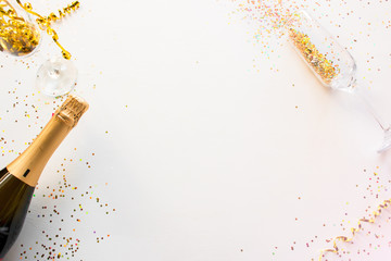 happy new year concept frame made of champagne and glasses on a white background with place for text