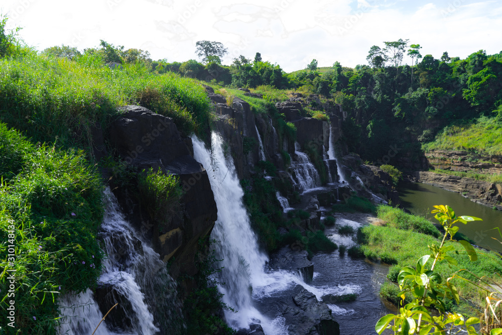  Amazing Pongour waterfall in Vietnam, Da Lat with the Buddha on the top.Travel concept ,wonderful view for crystal clear falling water in the rainforest. Beautiful nature wallper.