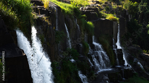  Amazing Pongour waterfall in Vietnam, Da Lat with the Buddha on the top.Travel concept ,wonderful view for crystal clear falling water in the rainforest. Beautiful nature wallper. photo