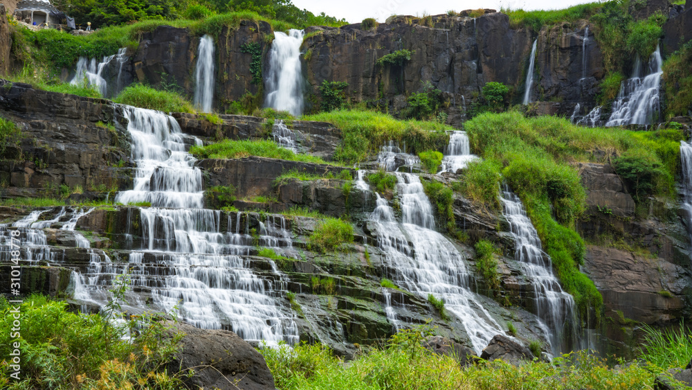 Amazing Pongour waterfall in Vietnam, Da Lat with the Buddha on the top.Travel concept ,wonderful view for crystal clear falling water in the rainforest. Beautiful nature wallper. Amazing Pongour waterfall in Vietnam, Da Lat with the Buddha on the top.Travel concept ,wonderful view for crystal clear falling water in the rainforest. Beautiful nature wallper.