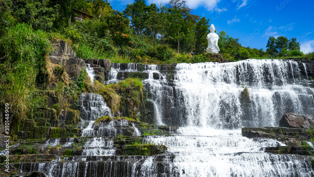  Amazing Pongour waterfall in Vietnam, Da Lat with the Buddha on the top.Travel concept ,wonderful view for crystal clear falling water in the rainforest. Beautiful nature wallper.