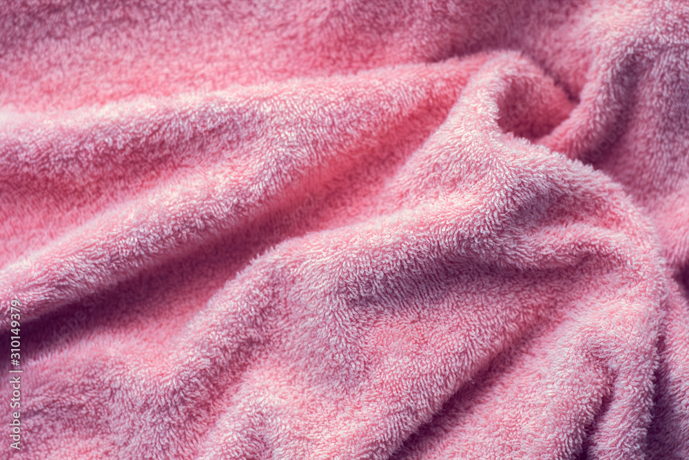 Texture of soft tissue fibers. Close-up.Fluffy Gentle baby fabric with  waves and folds. Soft pastel textile texture. Folds on the soft fabric.  Rose towel terry cloth. Photos