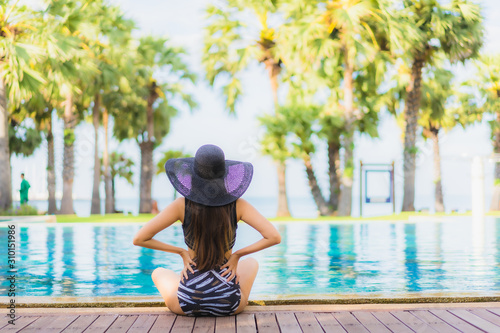 Portrait beautiful young asian women happy smile relax around swimming pool