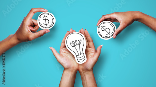 Hands with dollar sign coins and light bulb photo
