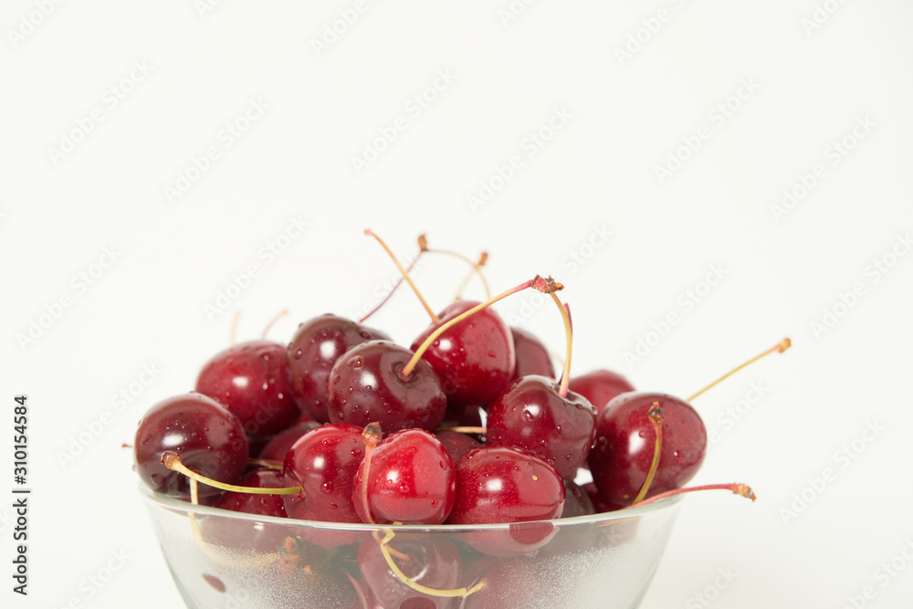 Fresh cherry glass bowl ready to serve. White background and perfect for adding text Fresh cherry glass bowl ready to serve. White background and perfect for adding text