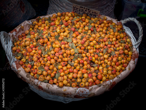 Wild fruit azarole, mediterranean medlar collected and sold in market photo