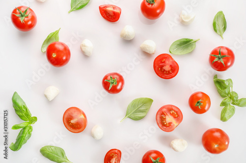 Ripe red cherry tomatos  and mozzarella on white background. Top view