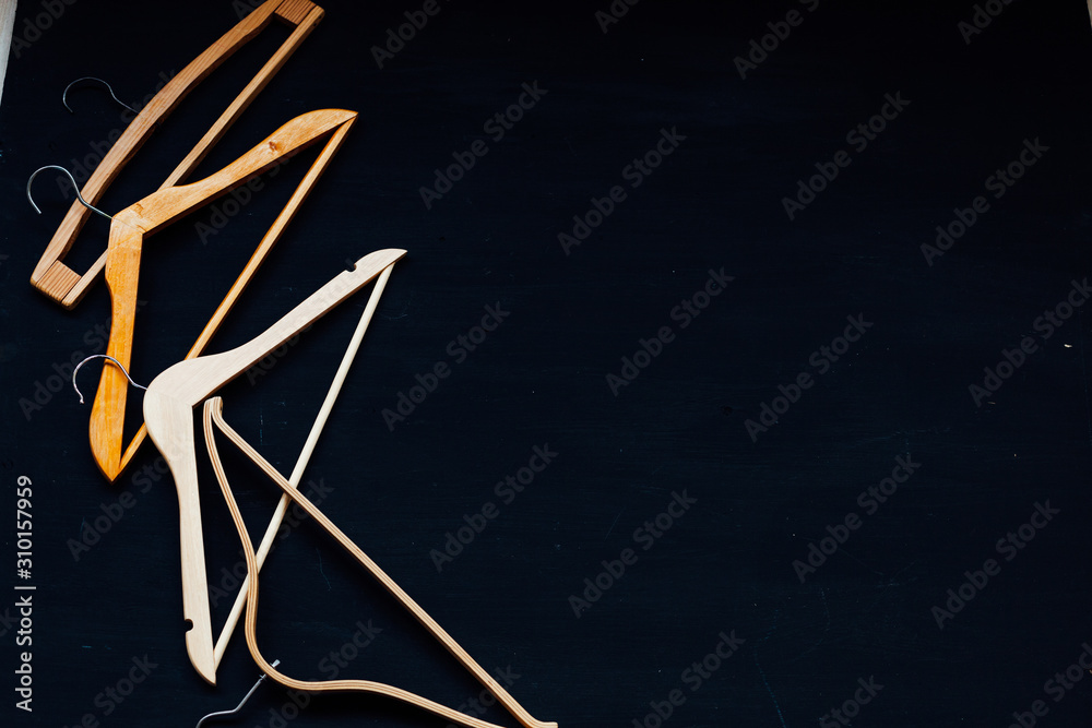 merchandise wooden hangers on a black background merchandise wooden hangers on a black background