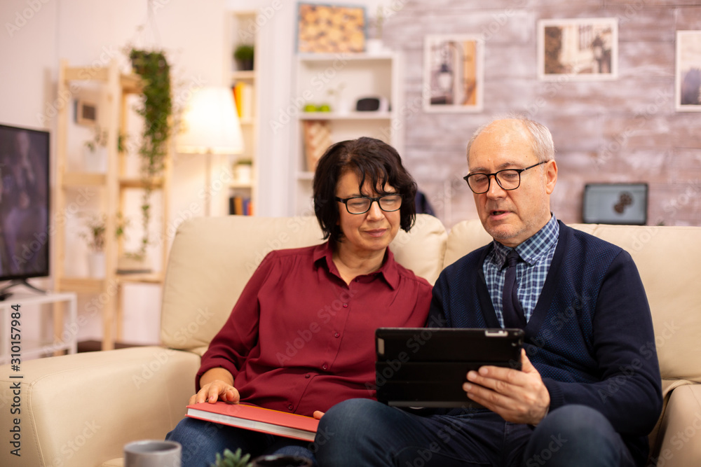 Beautiful old couple using a digital tablet to chat with their family Beautiful old couple using a digital tablet to chat with their family
