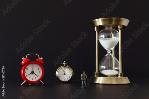 leadership business concept, man looking at clock and compass, deadline and challenge idea