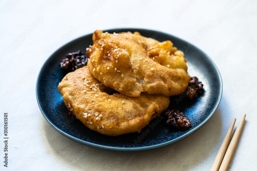 Fried Pineapple Fritters Caramelized with Cinnamon and Sesame Seeds. Fried Pineapple Fritters Caramelized with Cinnamon and Sesame Seeds.