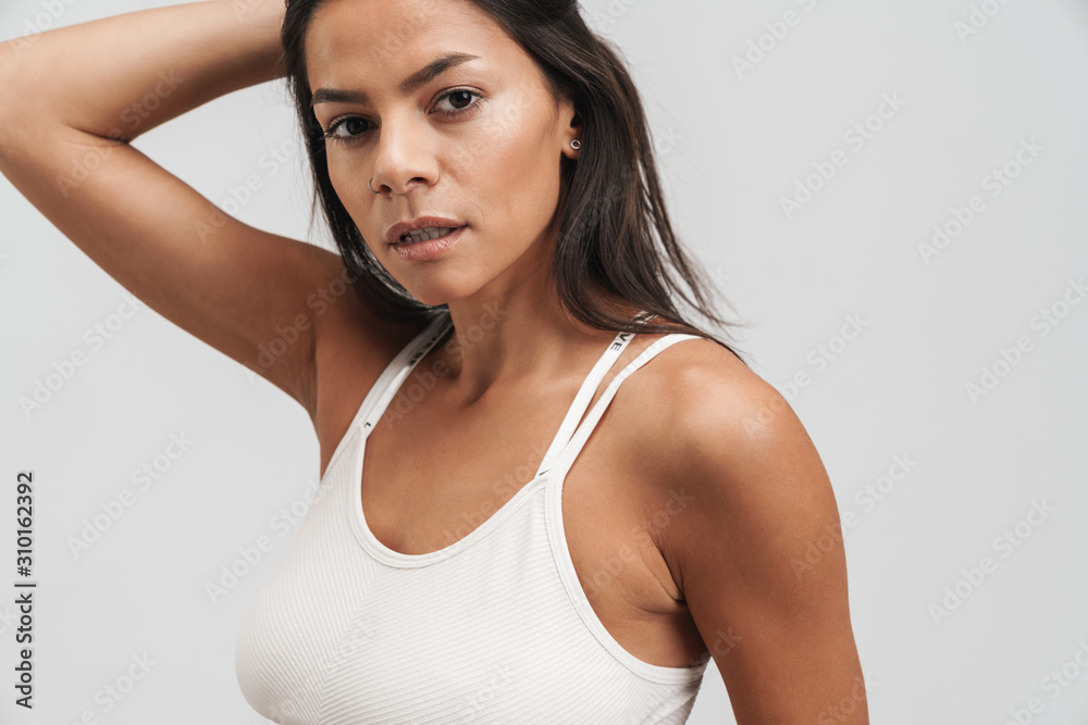Image of fitness woman in sportswear standing and looking at camera Image of fitness woman in sportswear standing and looking at camera