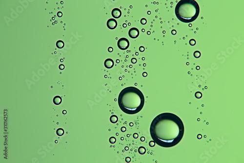 green wet background / raindrops for overlaying on a window, weather, background drops of rain water on a glass transparent