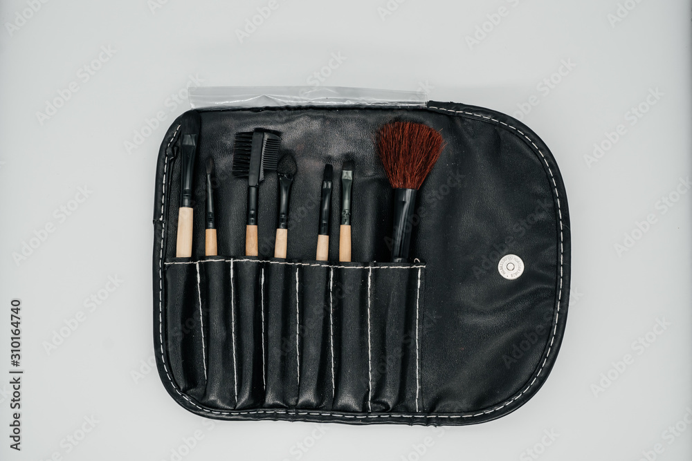 Set of makeup brushes on a light background close up Set of makeup brushes on a light background close up