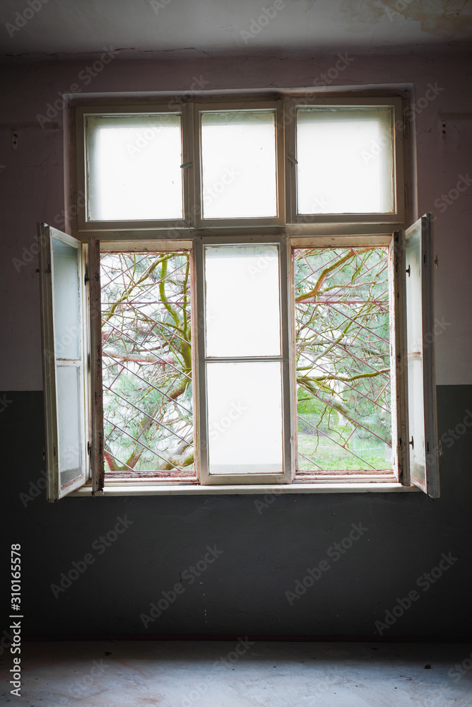 Barred window in a destroyed room, a prison of the mind and depression concept Barred window in a destroyed room, a prison of the mind and depression concept
