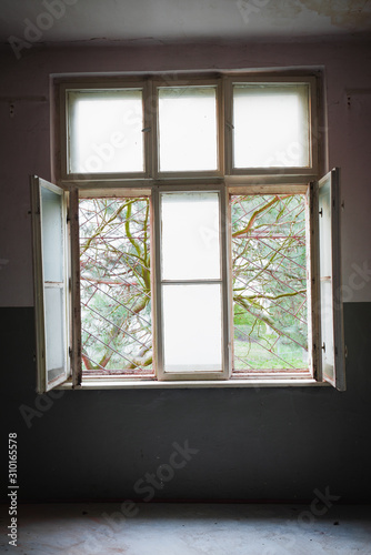 Barred window in a destroyed room  a prison of the mind and depression concept