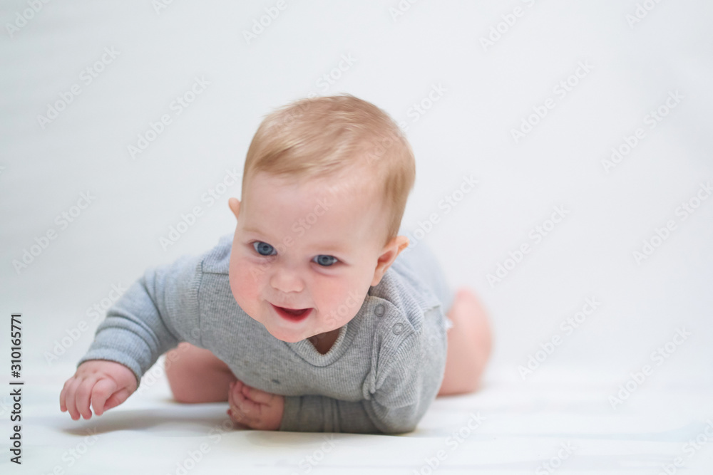 emotional portrait of a child. photo on a neutral background in gray clothes emotional portrait of a child. photo on a neutral background in gray clothes