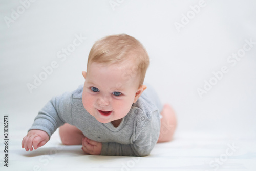 emotional portrait of a child. photo on a neutral background in gray clothes