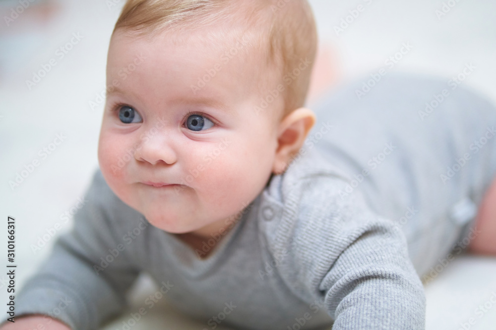 emotional portrait of a child. photo on a neutral background in gray clothes emotional portrait of a child. photo on a neutral background in gray clothes