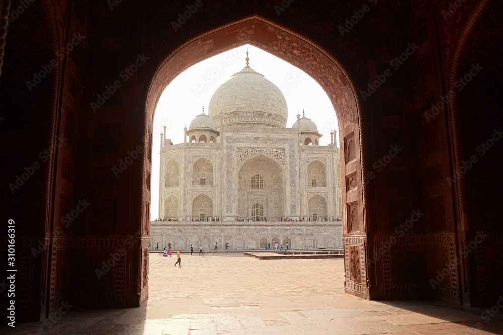 Fototapeta premium Agra, Uttar Pradesh, India - April, 2014: Side view of The Taj Mahal mausoleum, one of the seven wonders. Heritage building in Arabic style also is a mosque.