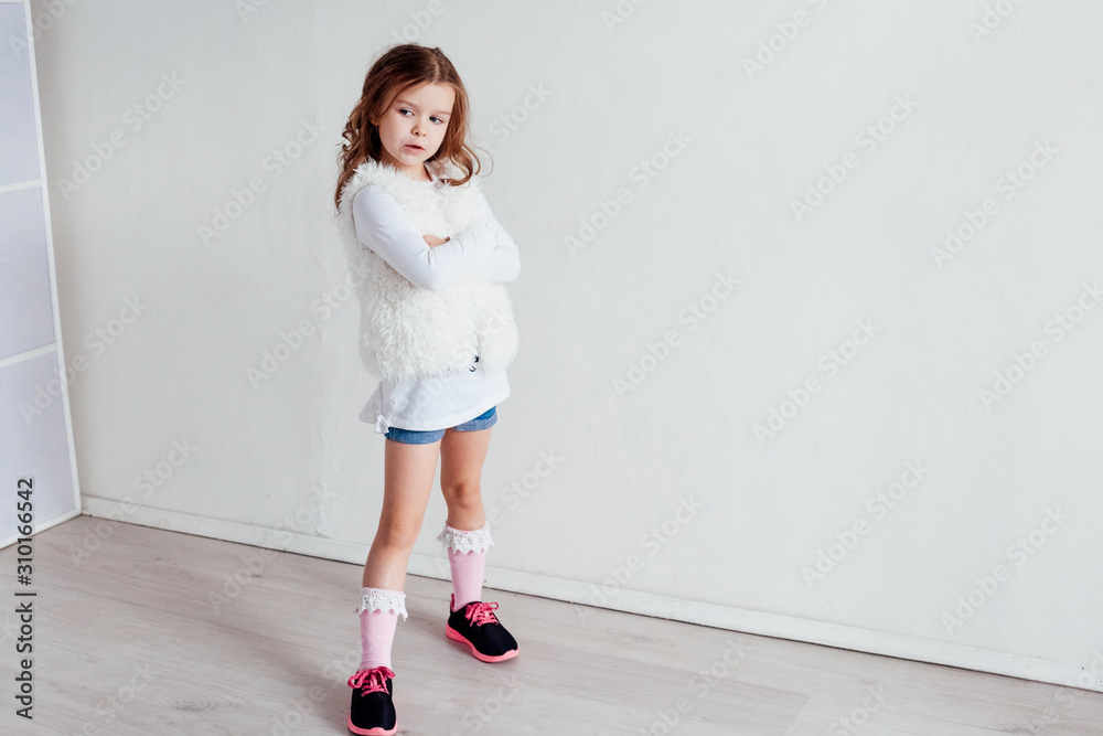 Portrait of a small beautiful fashion girl sits Portrait of a small beautiful fashion girl sits