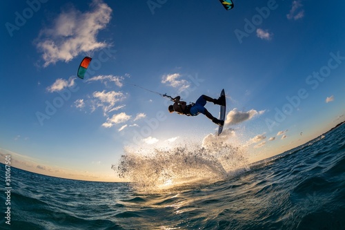 Photography Person surfing and flying a parachute at the same time in Kitesurfing