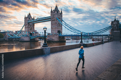 Running in London. Man train near by Tower Bridge, London, England,.