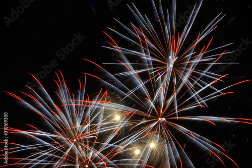 Colorful fireworks that explode and fill the darkness of the night sky with colored light.
