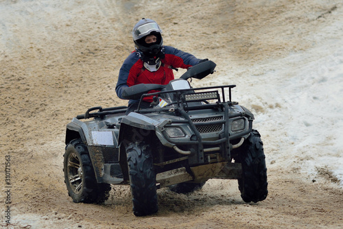 ATV and UTV driving in mud and snow at winter