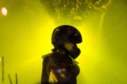 Go Go dancer in motorcycle helmet on the stage of night club photo