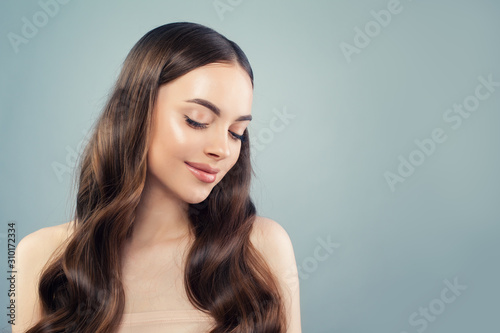 Young cute woman with long brown hair. Facial treatment, moisturizing and skin care concept