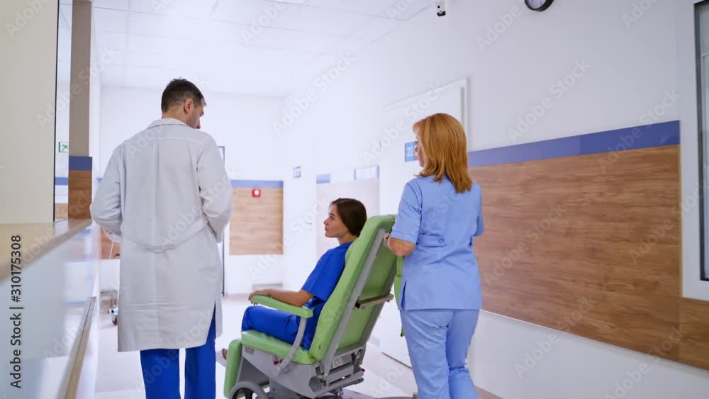 Woman patient in wheelchair. Professional doctor and nurse take care patient