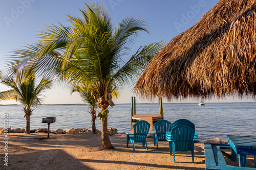 Beach chairs and tiki hut on the shore on a beach in Key Largo, Florida
