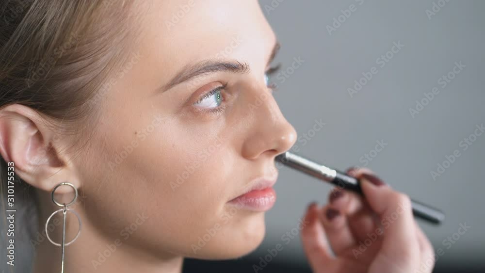 Close up portrait of model at the make up preparation. Close up portrait of model at the make up preparation.