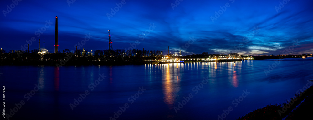 River rhine with oil refinery in the background, longtime shot