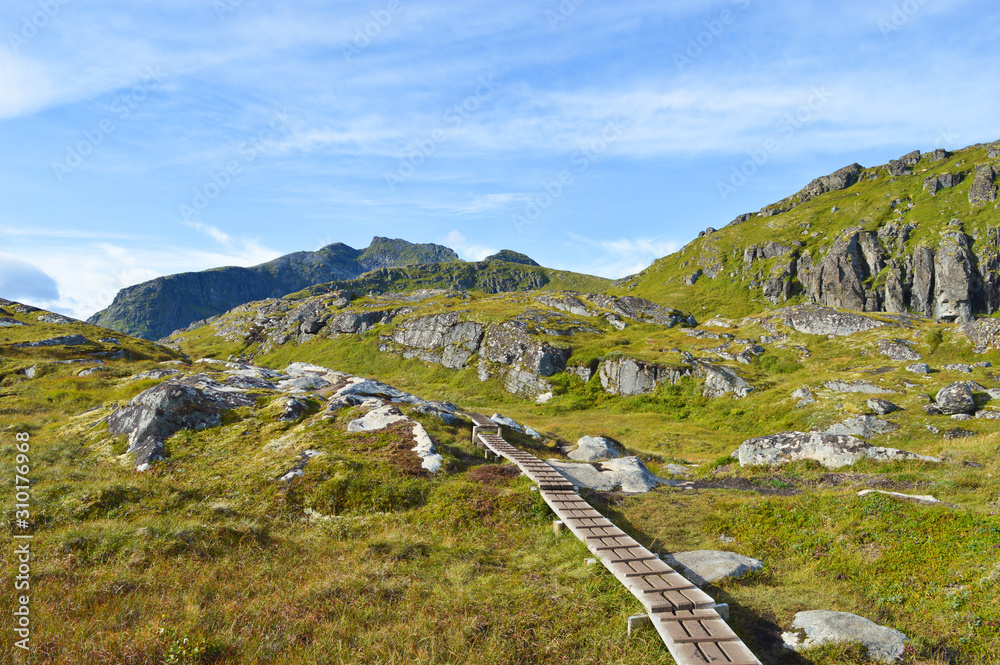 Wooden path in mountains near Kvalvika beach