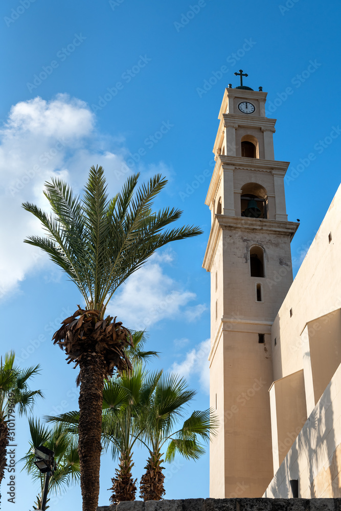 View on monastery Saint Peter with bell tower in Jaffa, Israel-Yafo. Clock Tower with Cross