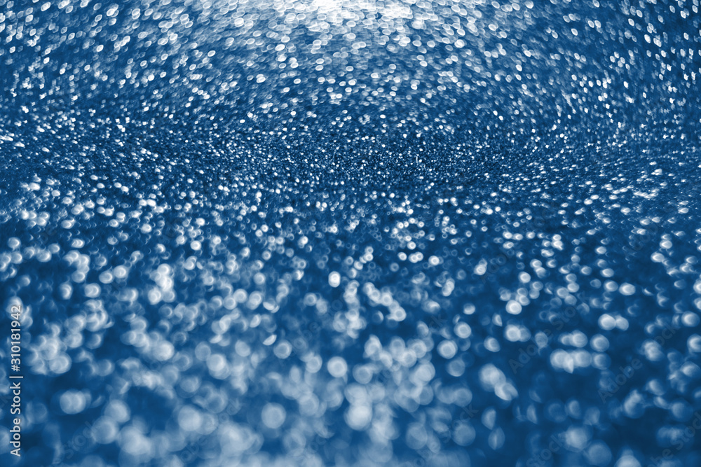 Holiday shiny bokeh background, glitter, sparkles, defocused glow. Pantone color of the 2020 year. Classic blue trend Holiday shiny bokeh background, glitter, sparkles, defocused glow. Pantone color of the 2020 year. Classic blue trend