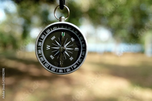 Black compass in natural scenery
