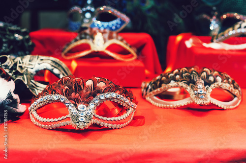 Venetian masks with plumage for carnival in showcase of shop in Venice, Italy