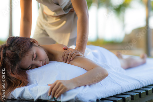 Asian woman getting Thai spa massage in the garden