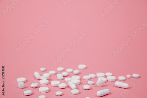 White medical pills on blue background.