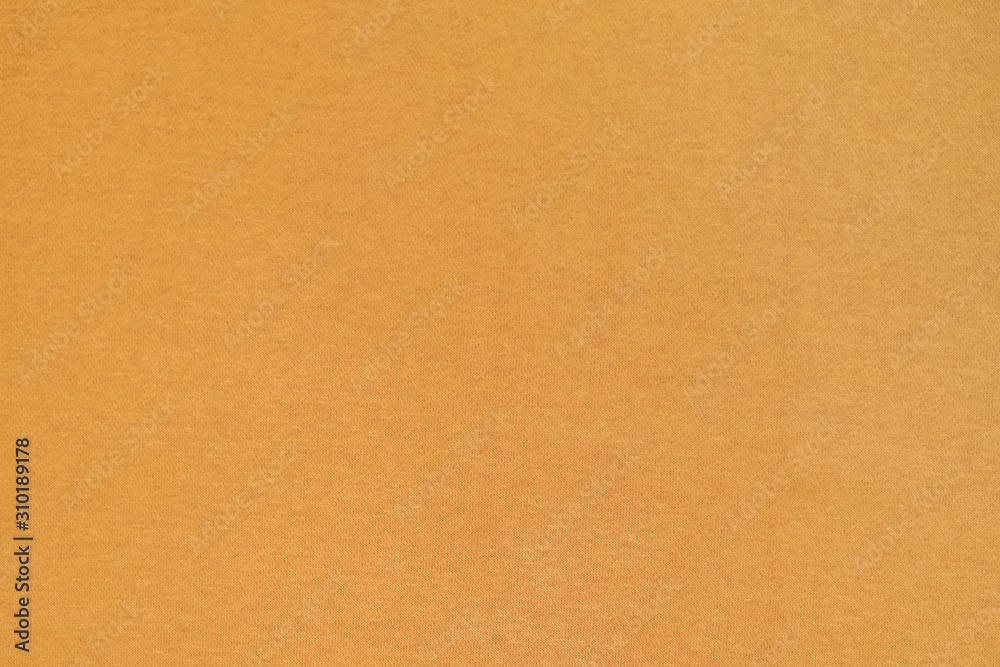 Homogeneous mustard color texture surface. Yellow ocher, fabric, background. Homogeneous mustard color texture surface. Yellow ocher, fabric, background.